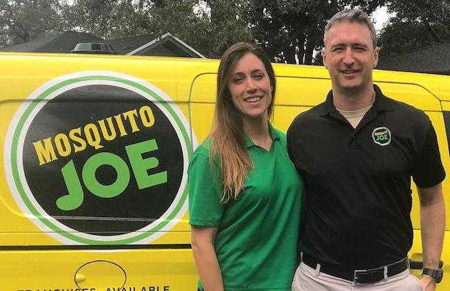 Sean and Sara Bess standing in front of a Mosquito Joe van